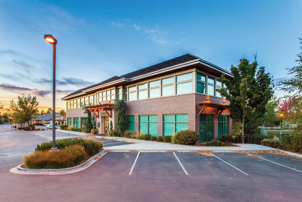 pexels-photo-1500459-1500459 A modern two-story office building in Eagle, ID, captured at sunset with a clear blue sky.